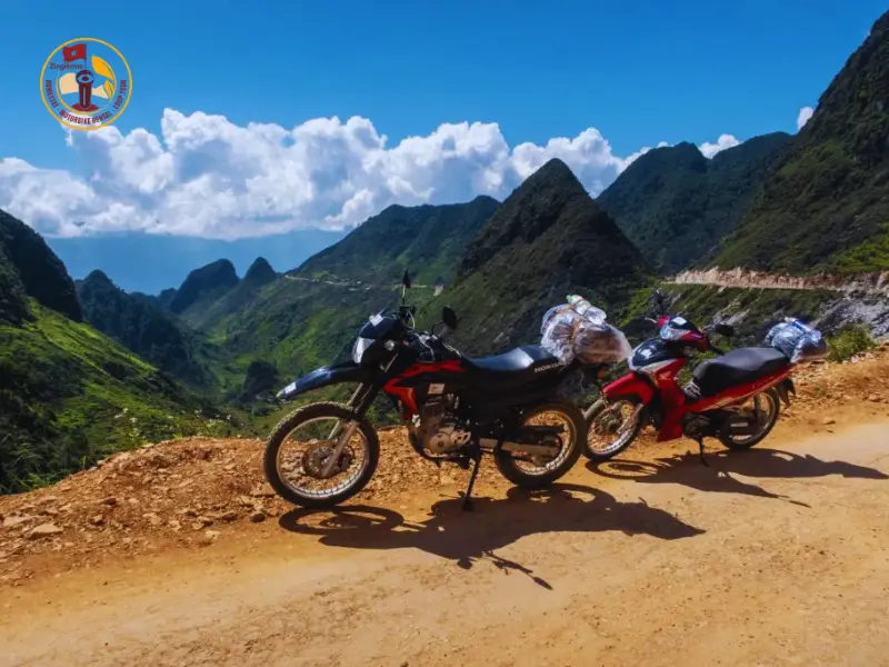 Tourists riding with professional Easy Rider drivers on the Mã Pí Lèng Pass, surrounded by majestic limestone mountains and small villages along the way.