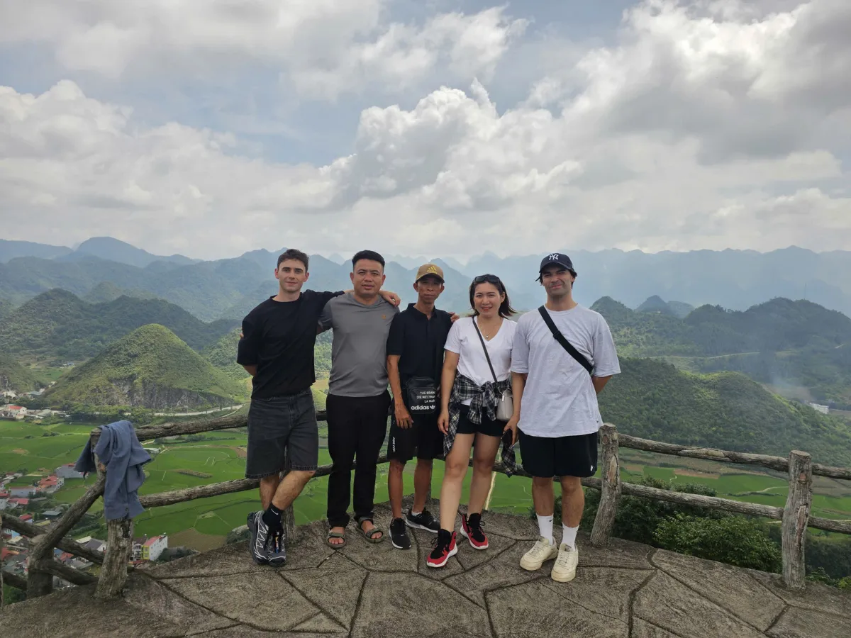Traveler standing at Quan Ba Heaven Gate overlooking majestic limestone mountains in Ha Giang in April